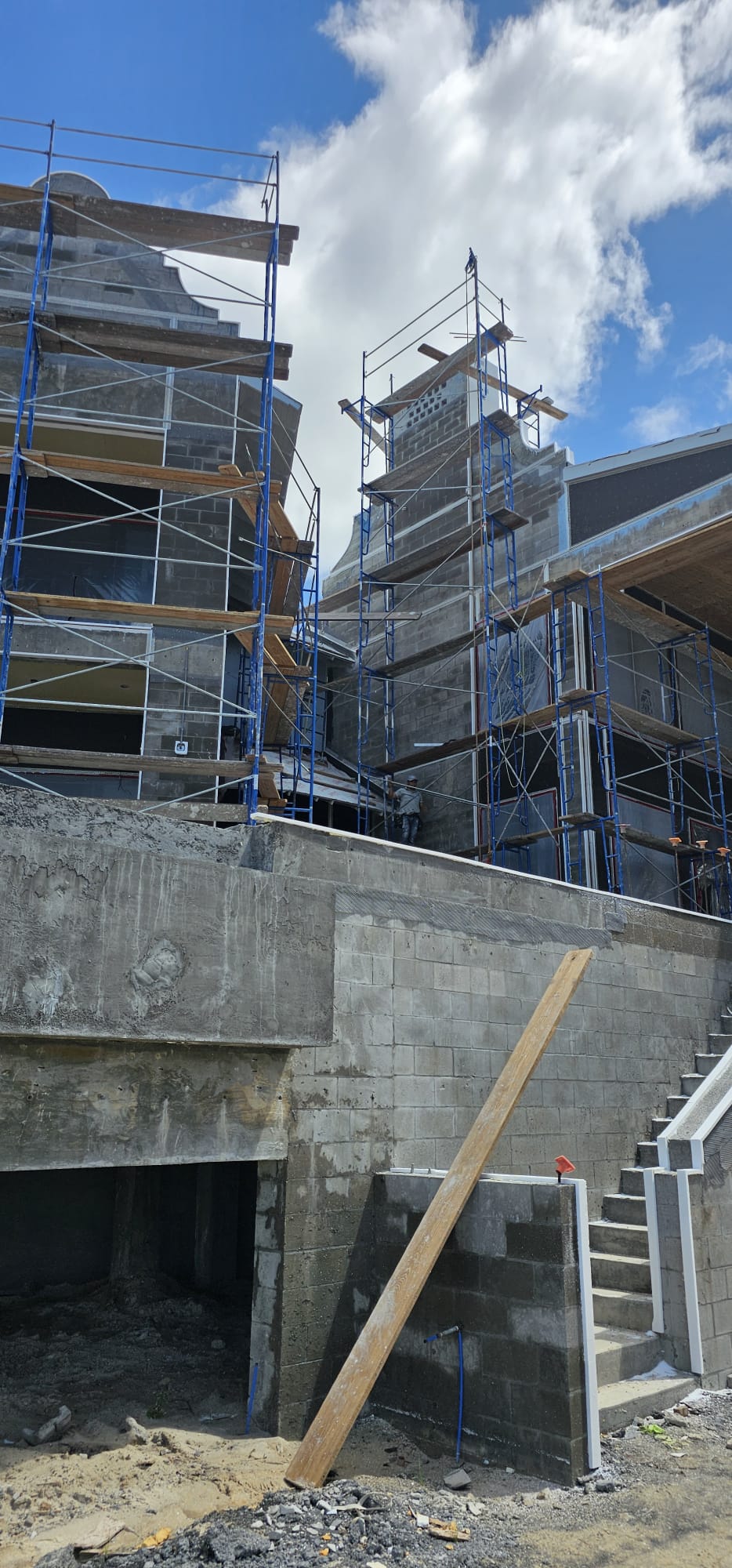 Large new construction with scaffolding for stucco