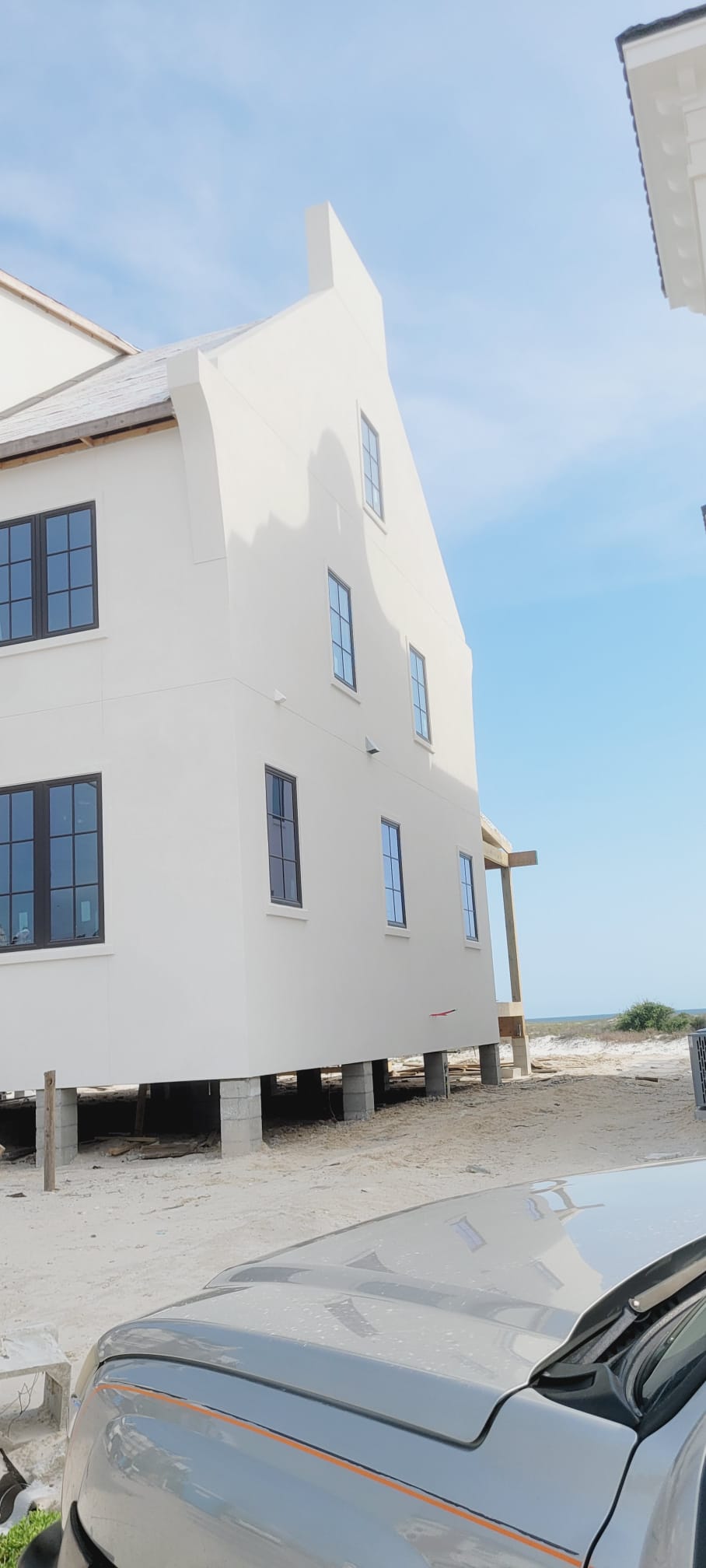 Coastal home on stilts stucco finish